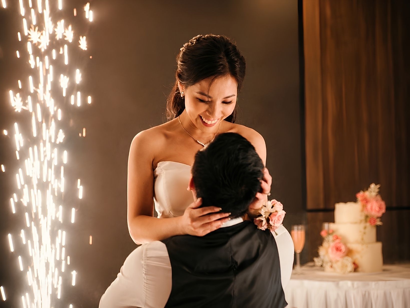 A newlywed couple sharing an intimate and joyful first-dance moment