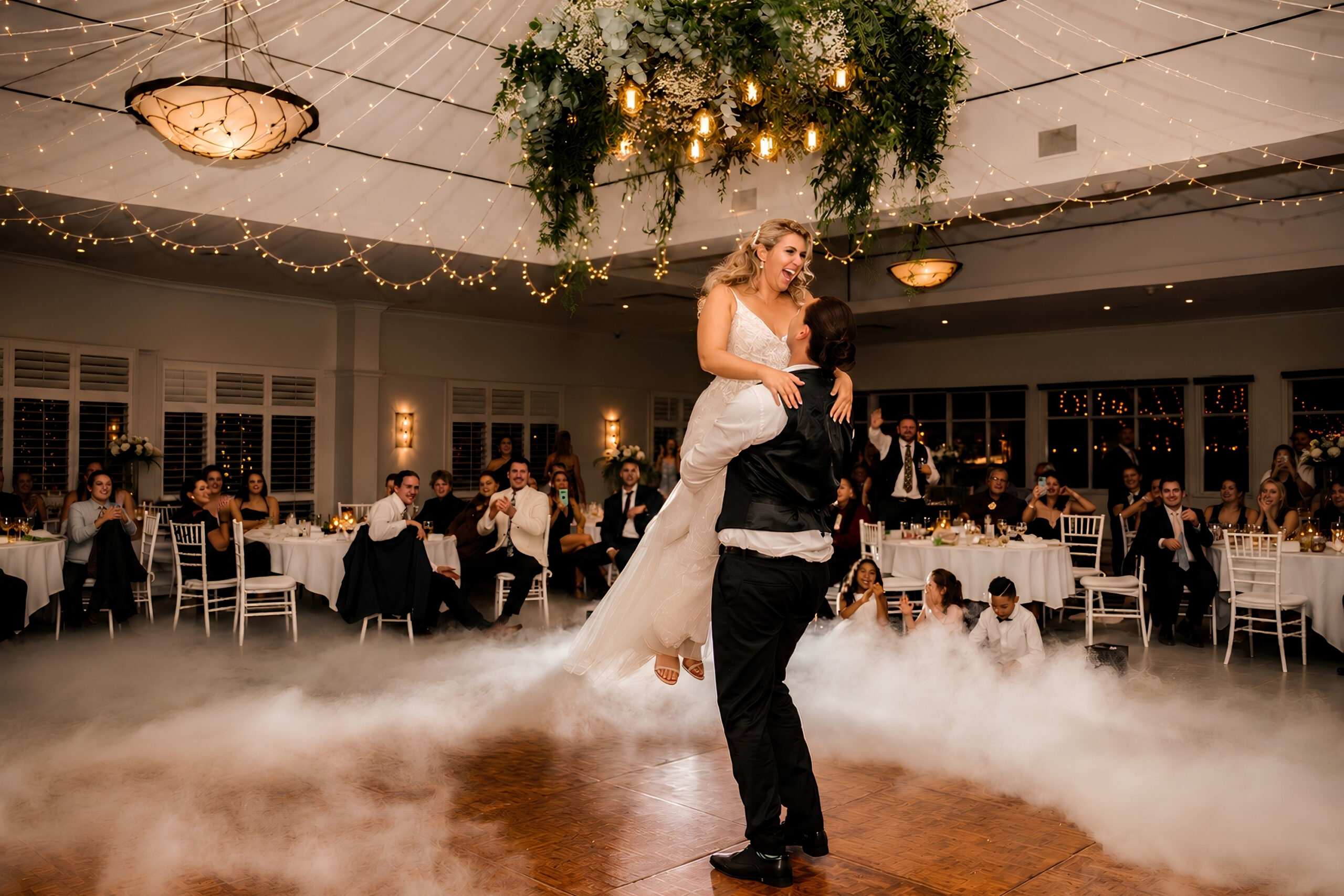 A couple sharing a joyful first dance moment at their wedding reception